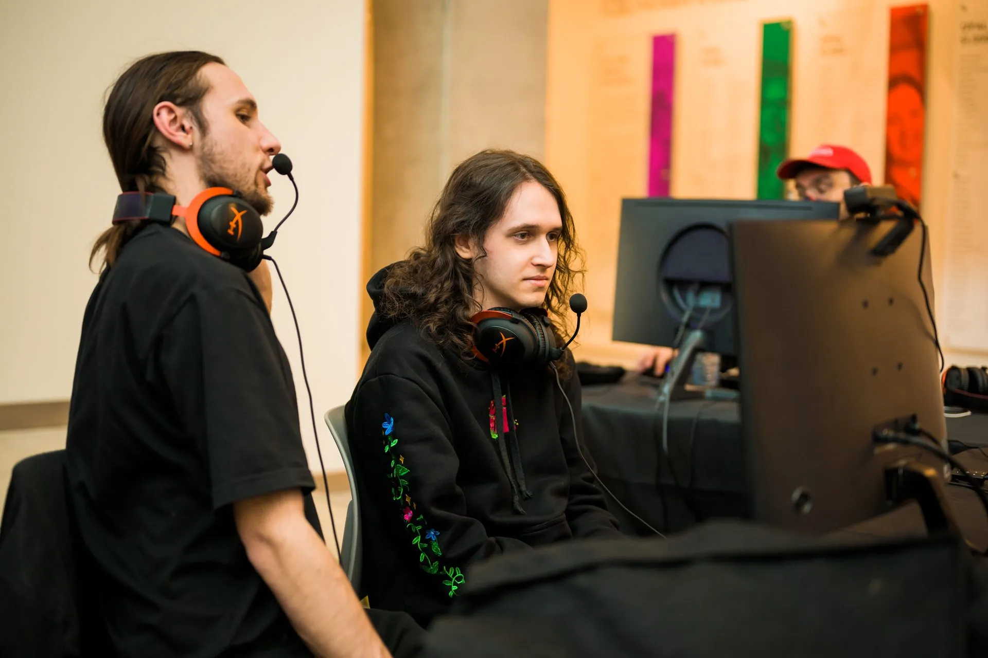 A competitor wearing a headset plays at a tournament station