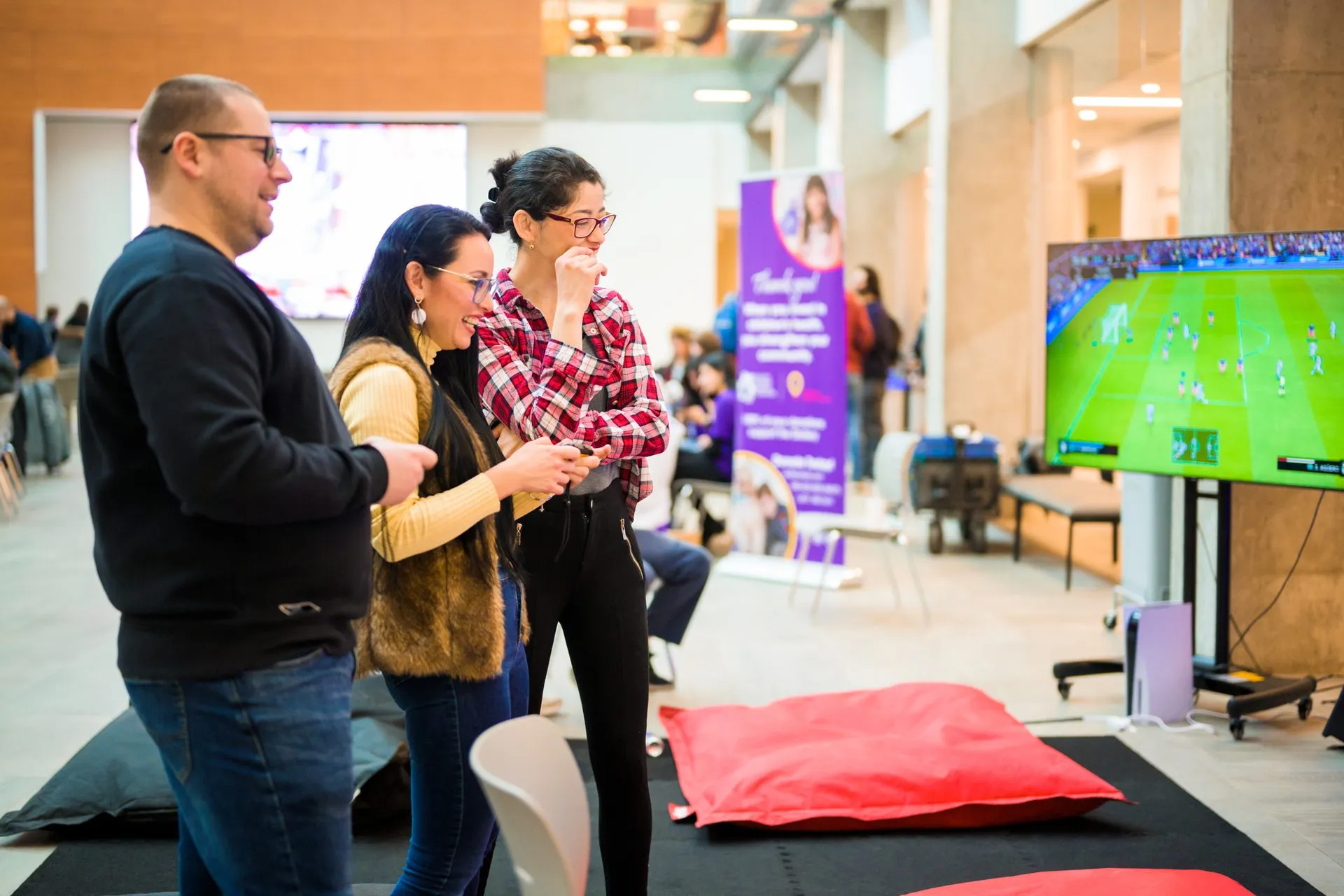 Attendees gather near a free-play screen at Canakup 2023