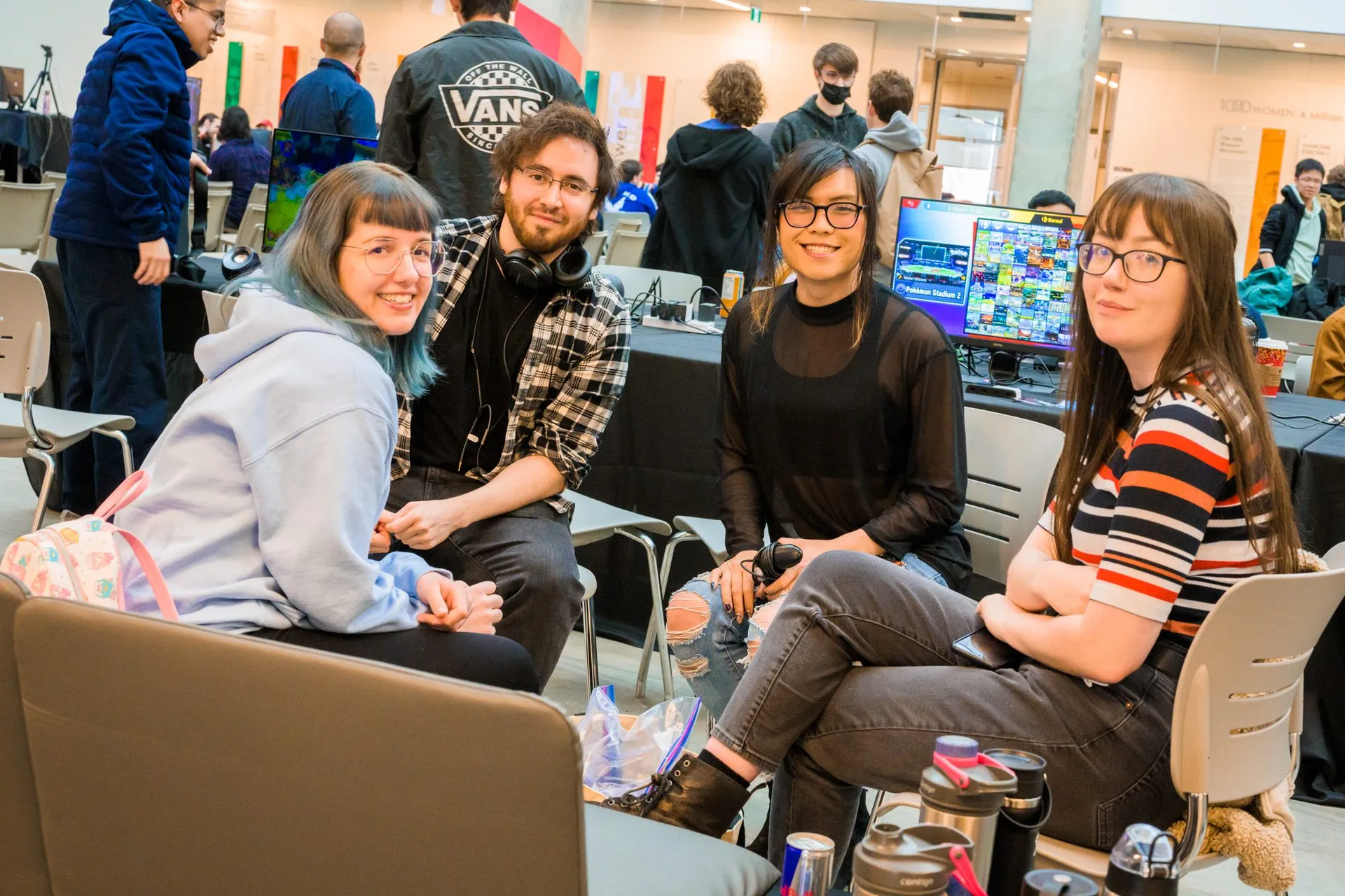 Friends sit together near the tournament stations at a Canakrn event