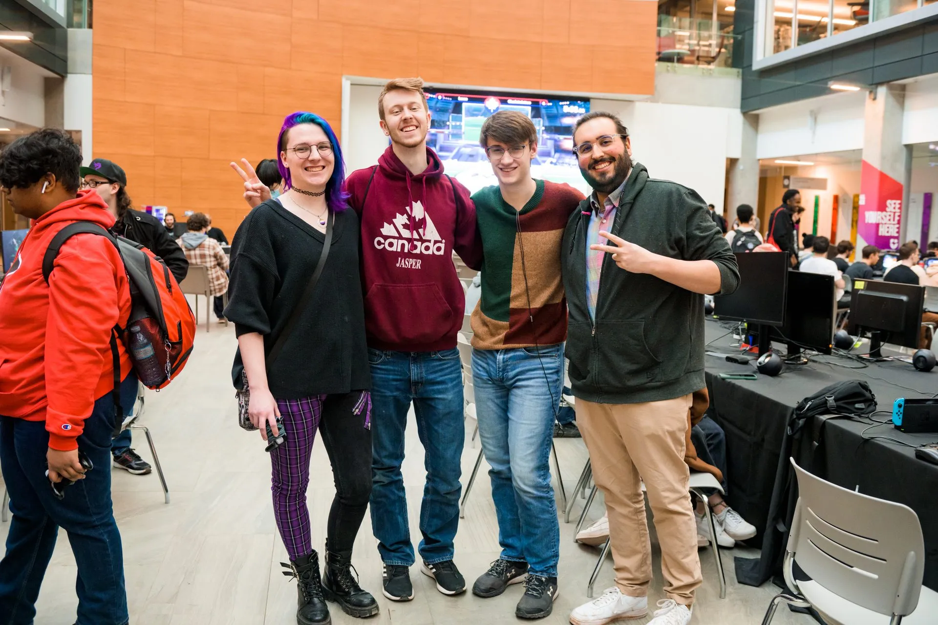Four attendees pose in front of tournament stations at Canakup 2023