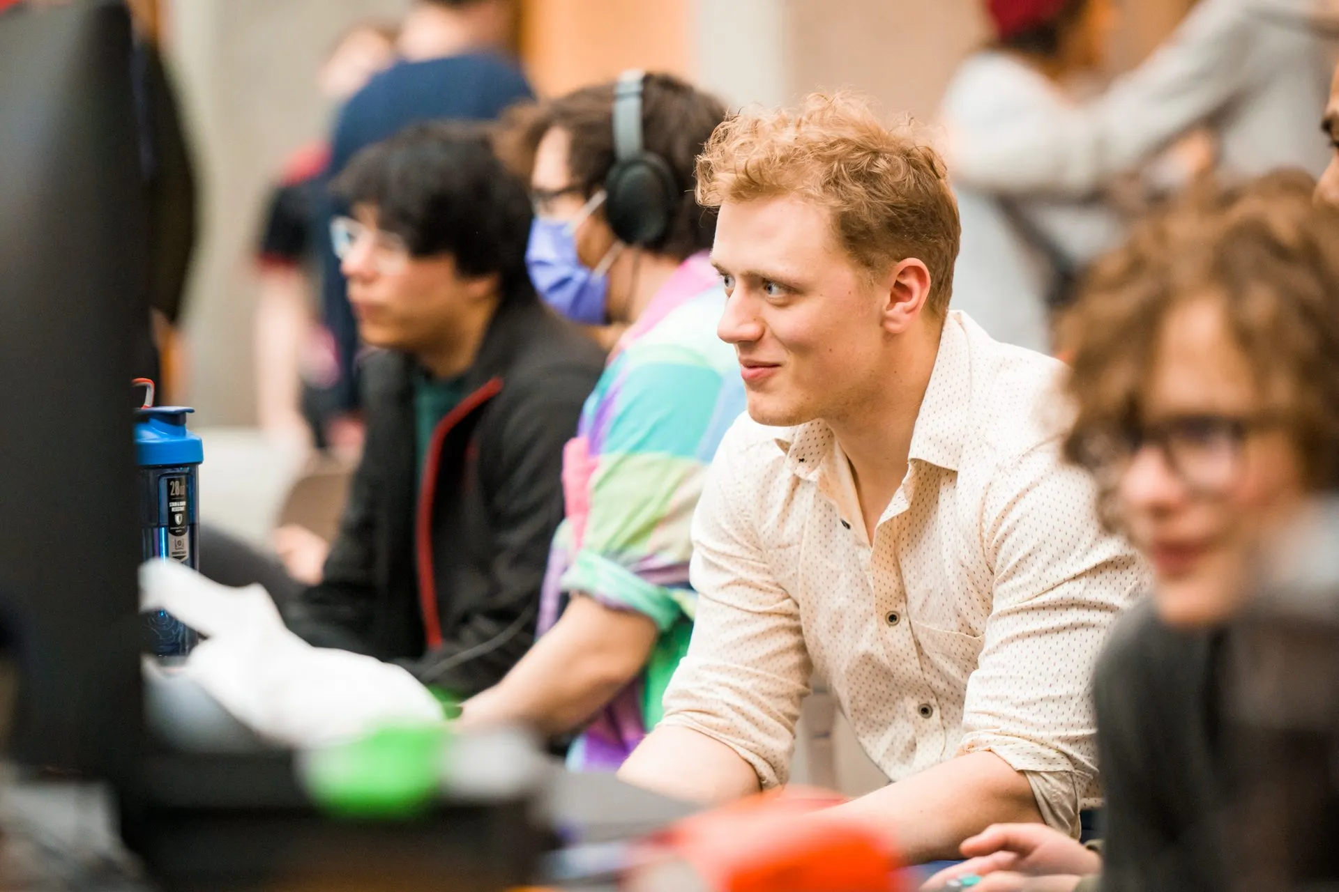 A competitor smiles at a tournament station as spectators watch at Canakup 2023